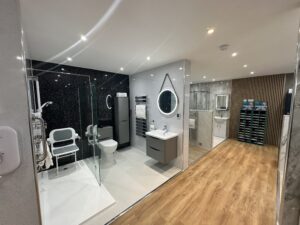 Contemporary Bathroom Showroom With Black Tiled Shower, Vanity & Fixtures