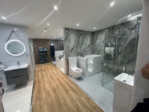 Modern Bathroom Showroom with Marble Wall, Vanity, Bidets & Glass Shower